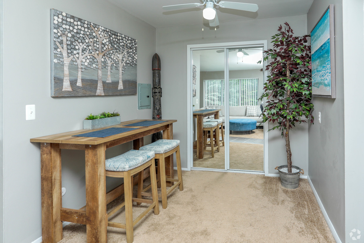 A room with a table and chairs in it